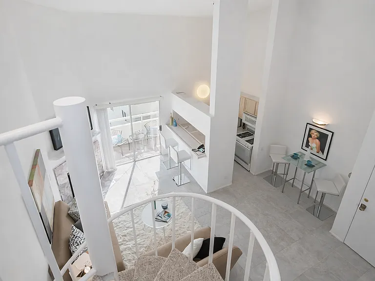a view from upstairs room to the lower portion of the home