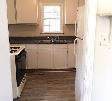 welcoming kitchen w/ new easy clean plank vinyl flooring