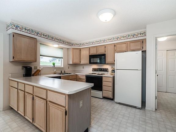 Kitchen w/ ample amounts of cabinet and counter space. Refrigerator stays!!