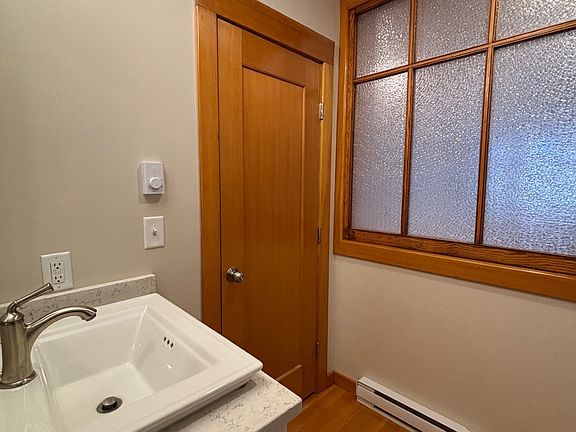 Bathroom, has a frosted window, with the kitchen on the other side