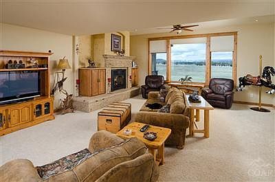 Large Living room with great mountain views overlooking the irrigated pastures.