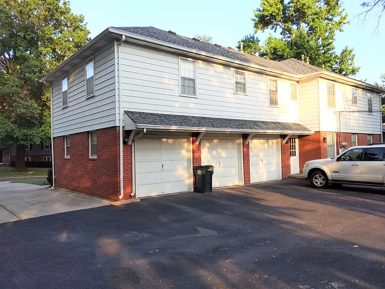 Back view drive with enclosed attached garage and rear private entrance.