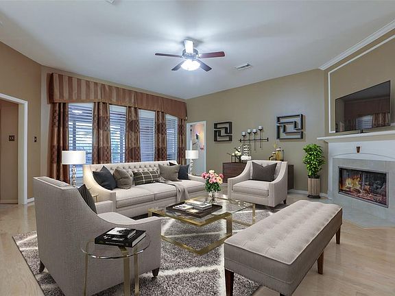 Design inspiration continues here - large living room overlooking an enclosed porch with bi-fold doors and a large covered patio and outdoor kitchen beyond it!