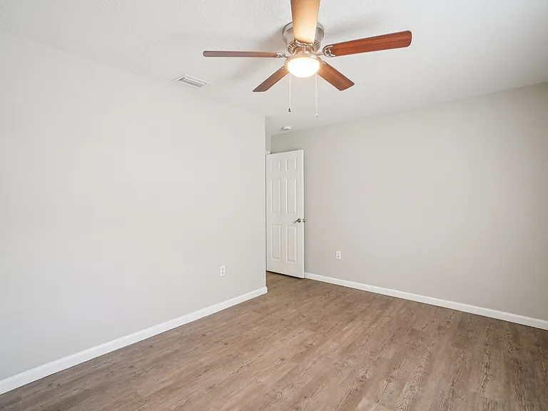 Shows the full depth of the room; no carpet anywhere for a clean, modern feel.