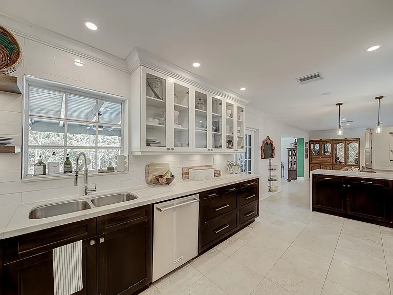Look out at the pool while doing dishes (that's what I do, very calming). Beautifully display your everyday dishes on the open shelving or glass cabinets.