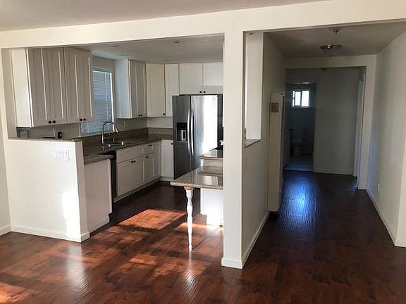 Kitchen has stailess steel refrigerator with ice machine and water dispenser, granite counters, gas stove.