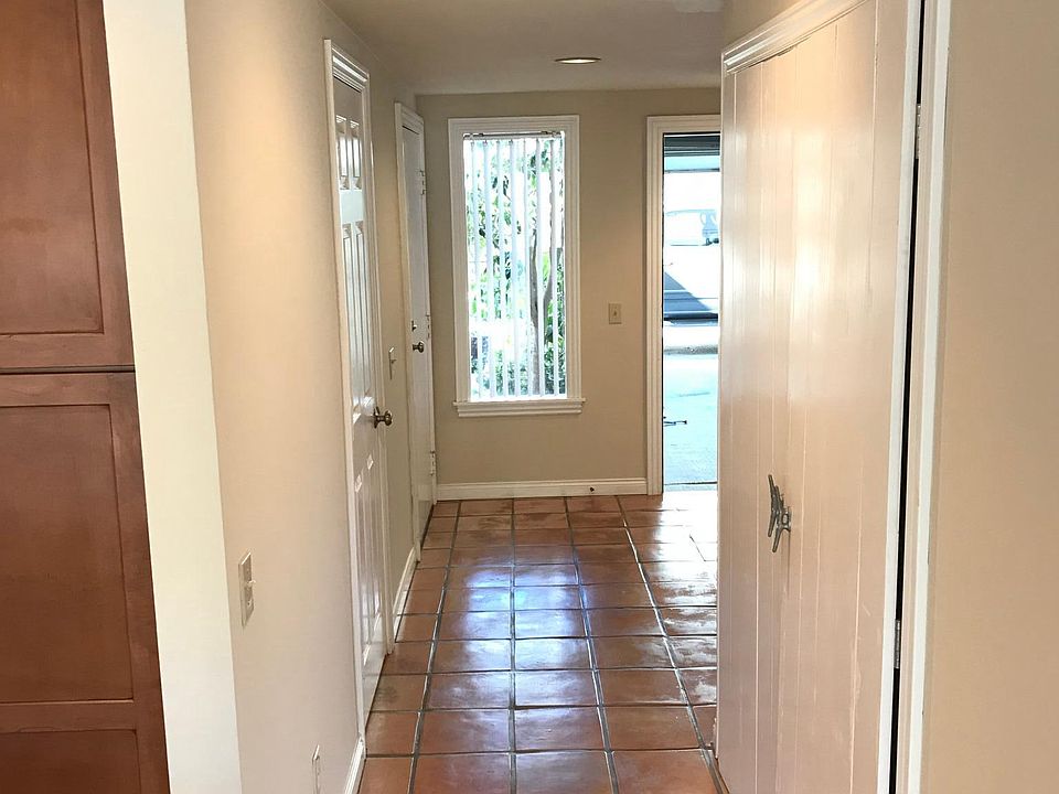 Entrance hall looking at private garage and front door. Half bath and laundry closet with full size w/d and deep sink
