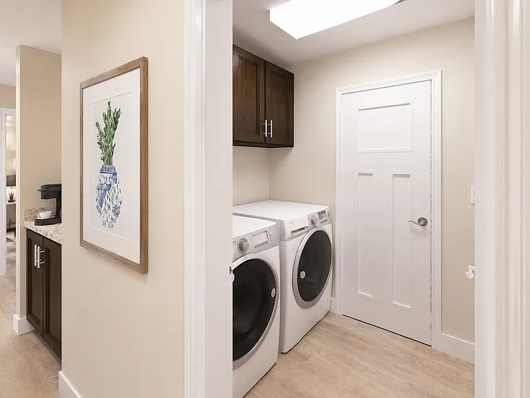 Convenient in-home laundry with modern appliances and clean, streamlined storage space.