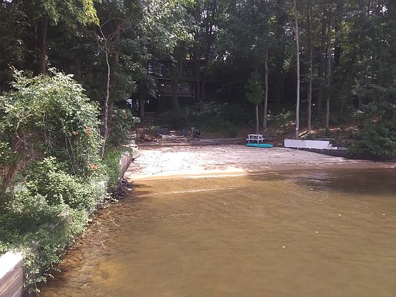 THIS IS THE BIGGEST BEST PRIVATE SANDY BEACH ONLAKE NORMAN. IT IS THE ENTIRE COVE. IT GENTLY SLOPES OUT TO A SAFETY LINE (NOT SHOWN). THERE IS A PICNIC TABLE AND GRILL AND FIREPIT THERE.