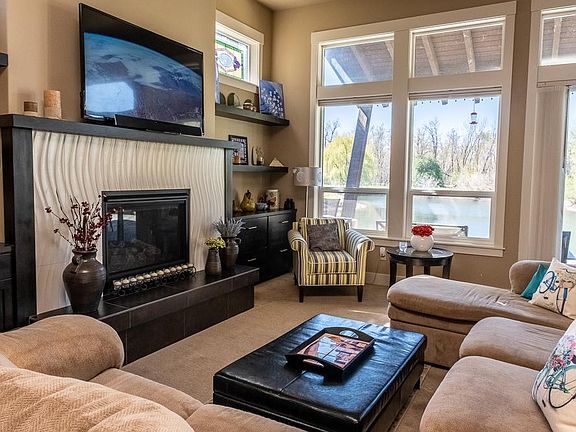 Open concept living room overlooking patio and lake