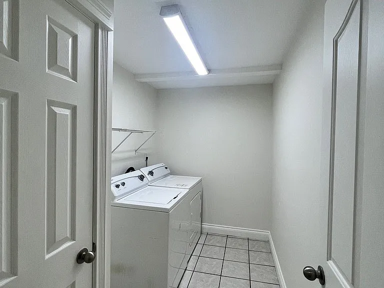 Separate laundry room with washer and dryer