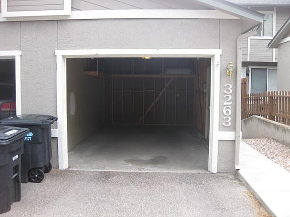 Over-sized one car garage in front of townhouse.