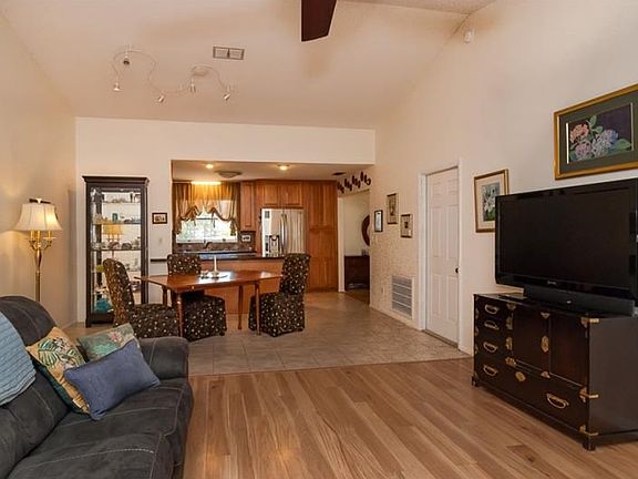 Greatroom with Lovely Wood finish laminate flooring and tile flooring in the dining area and Kitchen