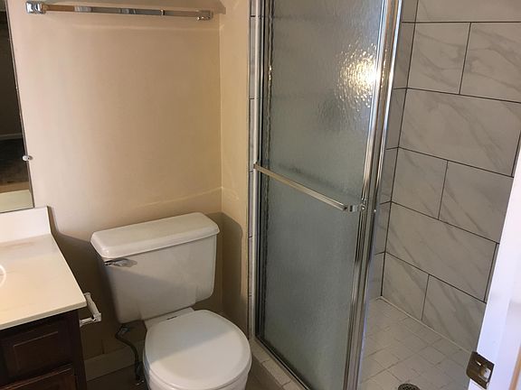 Master bath has new shower tile and features a separate dressing area with additional vanity.