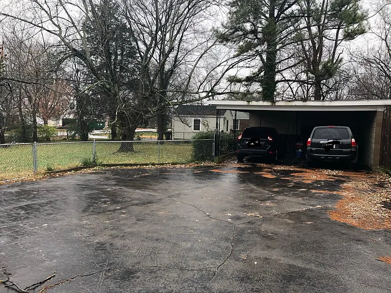 2 car covered carport with attached workshop in back and ample driveway parking