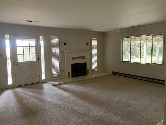 Living Room with fireplace and lots of natural light.