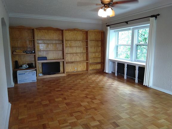 This is the west end of the living room. The window shown looks north into West Side Park. To the left is the wide hallway that leads down the center of the condo.