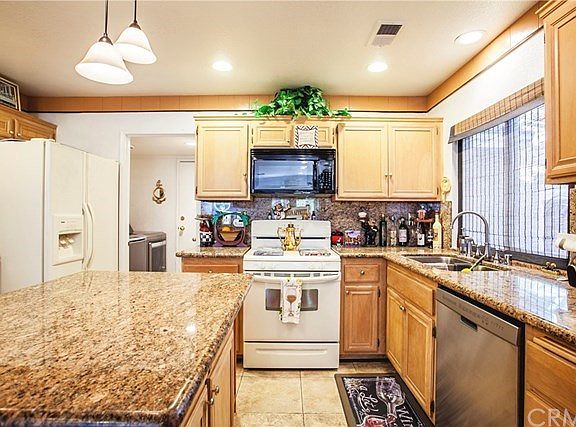 Upgraded kitchen with granite counter tops and a center island/breakfast bar