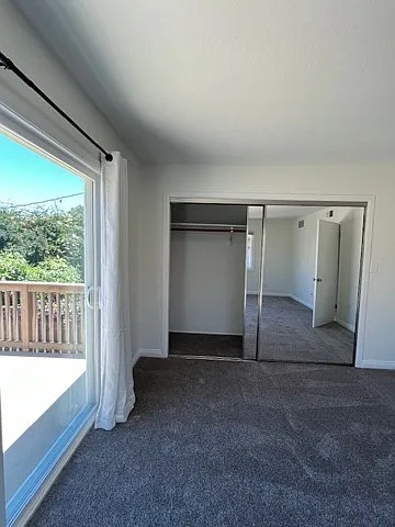 Second upstairs bedroom opening onto rear-facing deck