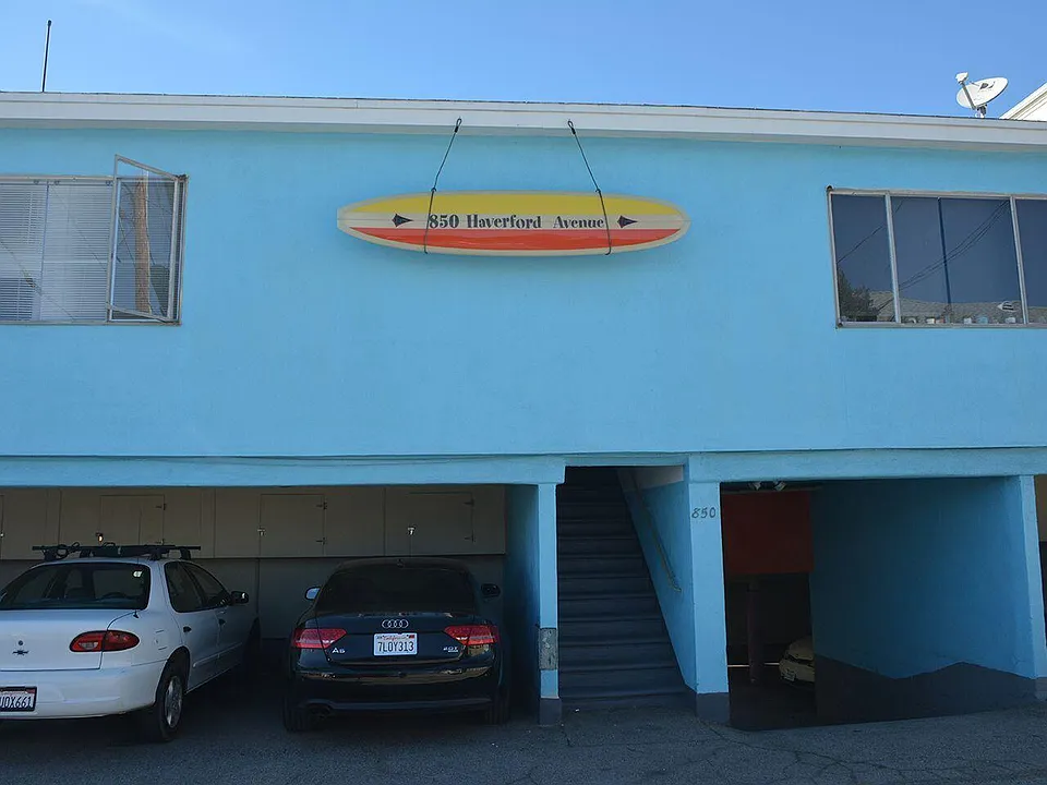 Custom-made Address Surfboard at Alley entrance.
