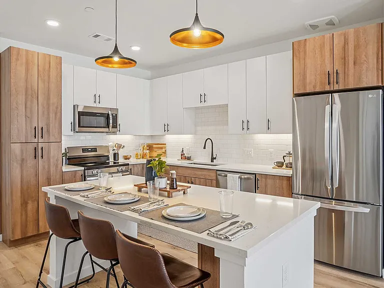 Modern finishes, stainless-steel appliances, and spacious kitchen islands create a space designed for both everyday living and entertaining.
