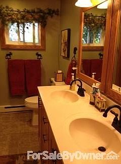 View of bathroom.
						:
						Dual sinks with solid surface counter tops and tile floor.