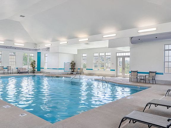 Experience year-round indulgence in the community's world-class indoor heated lap pool. Whether it's a rainy day or the middle of winter, this resort-style amenity offers a climate-controlled sanctuary for fitness and relaxation just steps from your door.