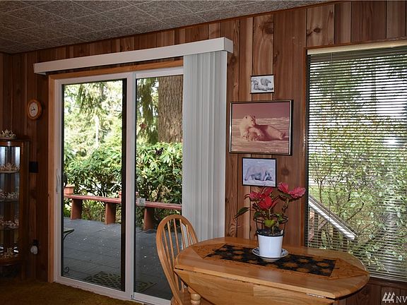 Sliding glass door in the living room. Currently used as the main entrance to the house. This door is double pane glass.