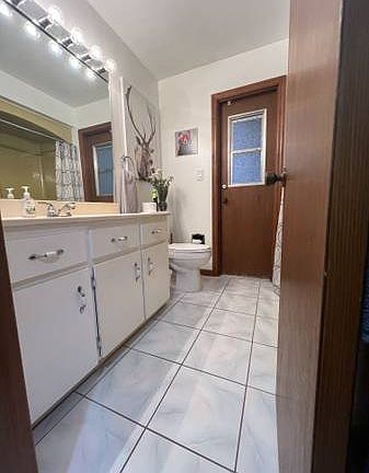 Shared bathroom with door exit to the pool area