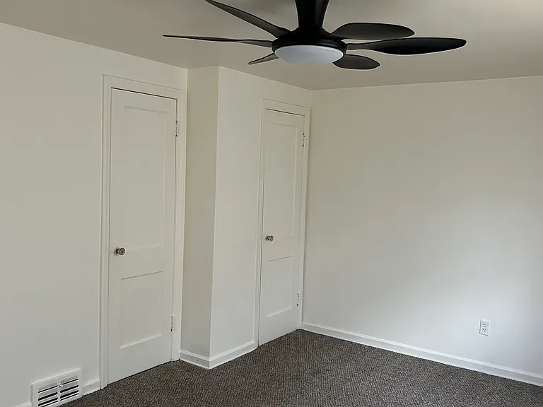 Primary bedroom with dual closets for added storage and organization.