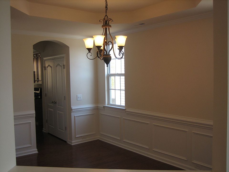 Dining room w/ trey ceiling, wood floors, chair rail, etc.