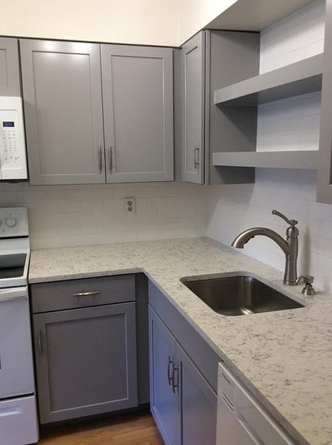 New kitchen with quartz counterrtop, painted cabinets, new white appliances.
