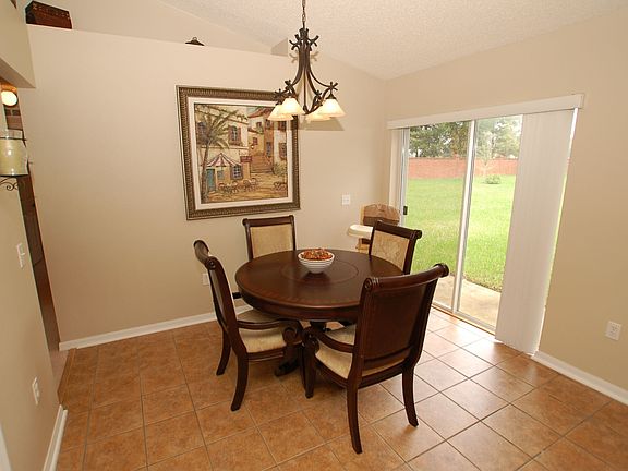 Separate eat-in breakfast nook in kitchen with sliding door to backyard.