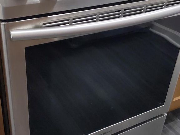 This electric range is set in a large island with lots of extra storage.
