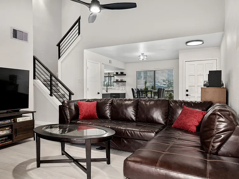 Living room with ceiling fan and light hardwood / wood-style flooring
