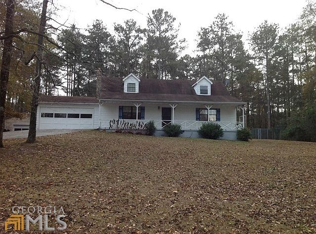 Front view of Home with long front porch and sizable yard for play.