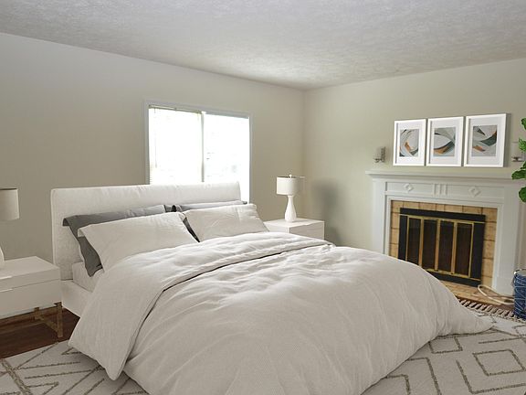 Primary bedroom with a fireplace - virtually staged