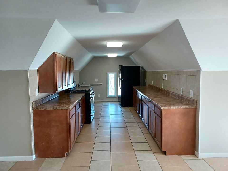 Galley kitchen with access to interior door of the apartment.