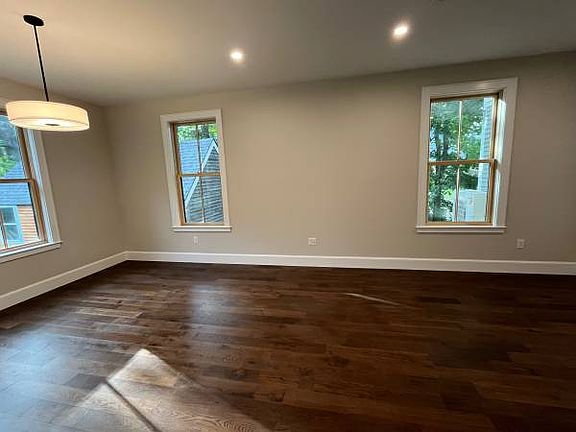 Living room, side windows on Meadow Lane with our shed visible.