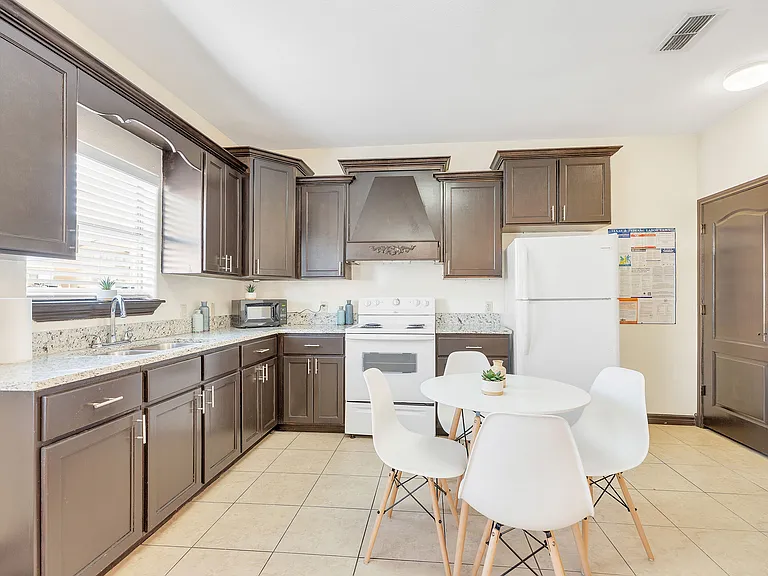 Kitchen space in Merida Vista Apartments, Laredo, Texas, with a table and chairs arranged for dining
