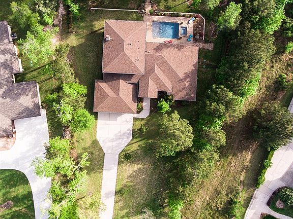 Bird's eye view of this fabulous custom home nestled in the woods and yet minutes from the city. The best of country living!