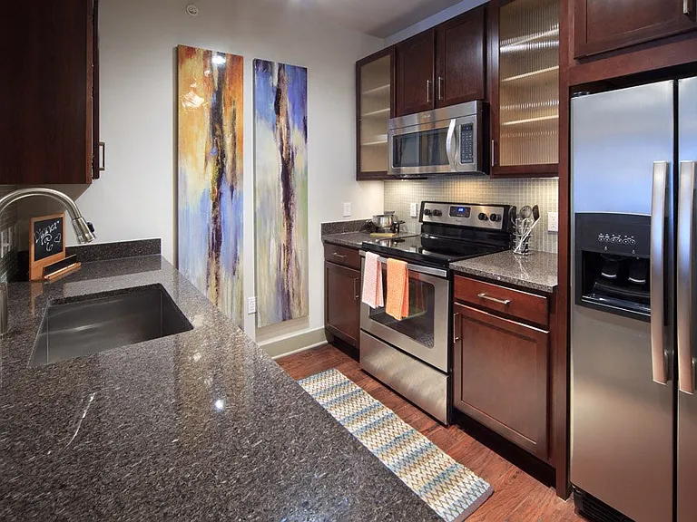 Black granite counters with dark cherry cabinets