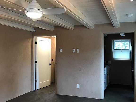 Living area looking west to bath and kitchen entries