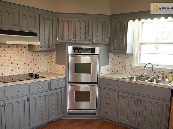 Kitchen features stainless steel appliances including double ovens, brand new cooktop, refrigerator and newer dishwasher.  Freshly painted kitchen cabinets.  .