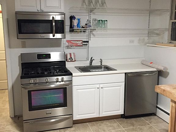 Kitchen with refrigerator, microwave, gas range, dishwasher 
