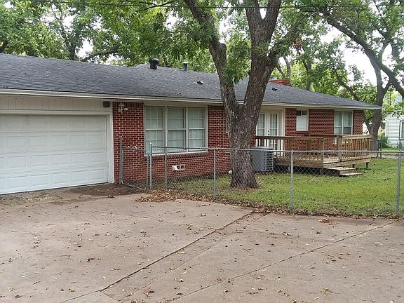 Double Car Garage plus room for one car in front of the garage door. The Drive that goes to the right is not included. The small yard enclosed by the chain fencing is the back yard for this house.
