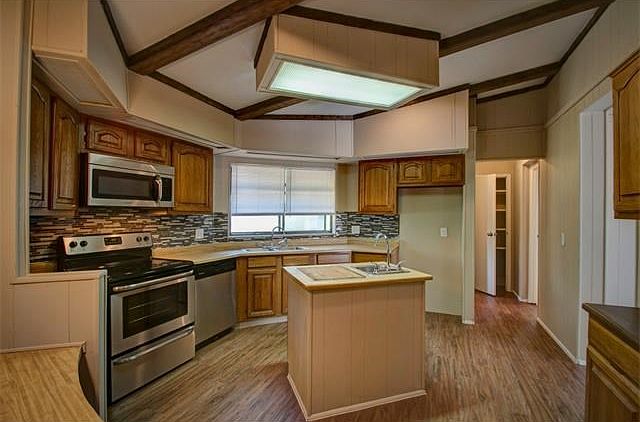 Kitchen area featuring all new stainless steel appliances, t