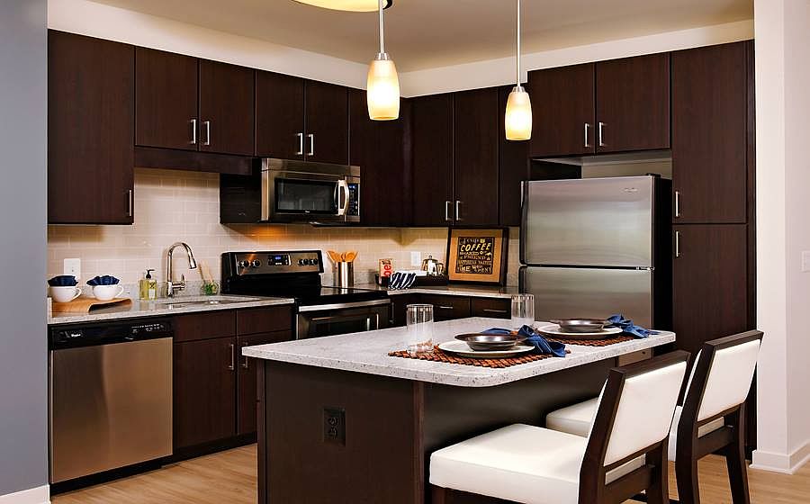 Kitchen with granite countertops, stainless steel appliances, tile backsplash, island and hard surface flooring
