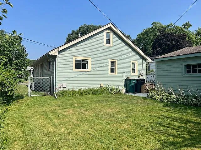 completely fenced rear yard with perienial gardens
