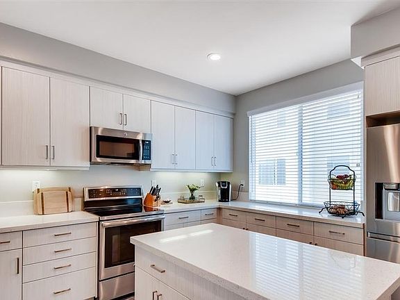 The kitchen is spacious with a prep island and plenty of cabinets for storage